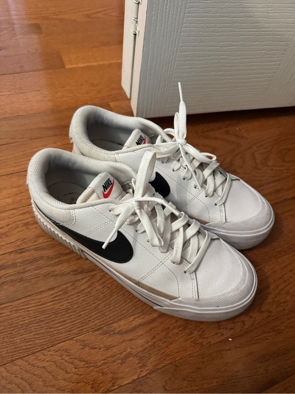 Nike White Low-Top Sneakers with Black Swoosh and Tan Accent